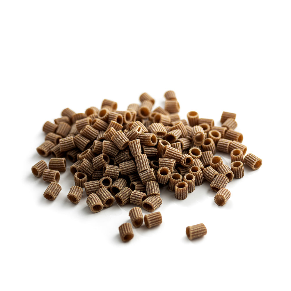 small pile of organic wholegrain einkorn ditalini pasta from carleschi 