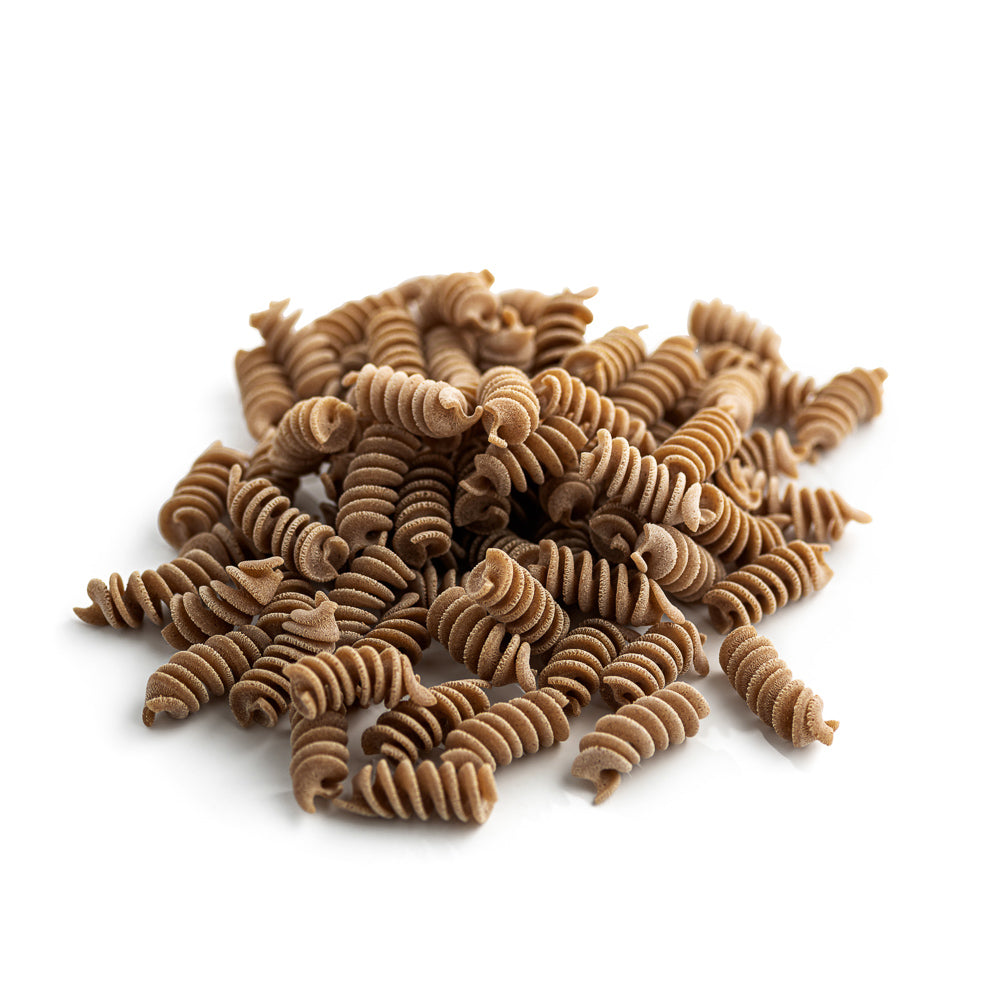 small pile of organic wholegrain spelt and peas fusilli pasta from carleschi 