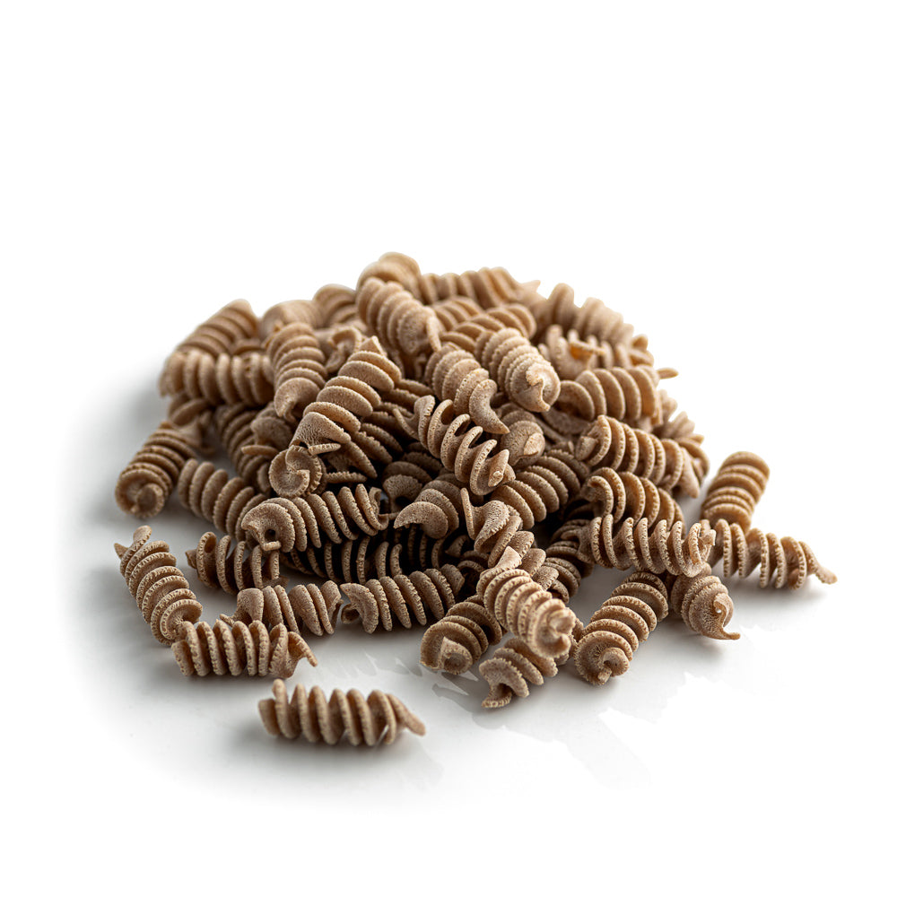 small pile of organic wholegrain spelt fusilli pasta from carleschi 